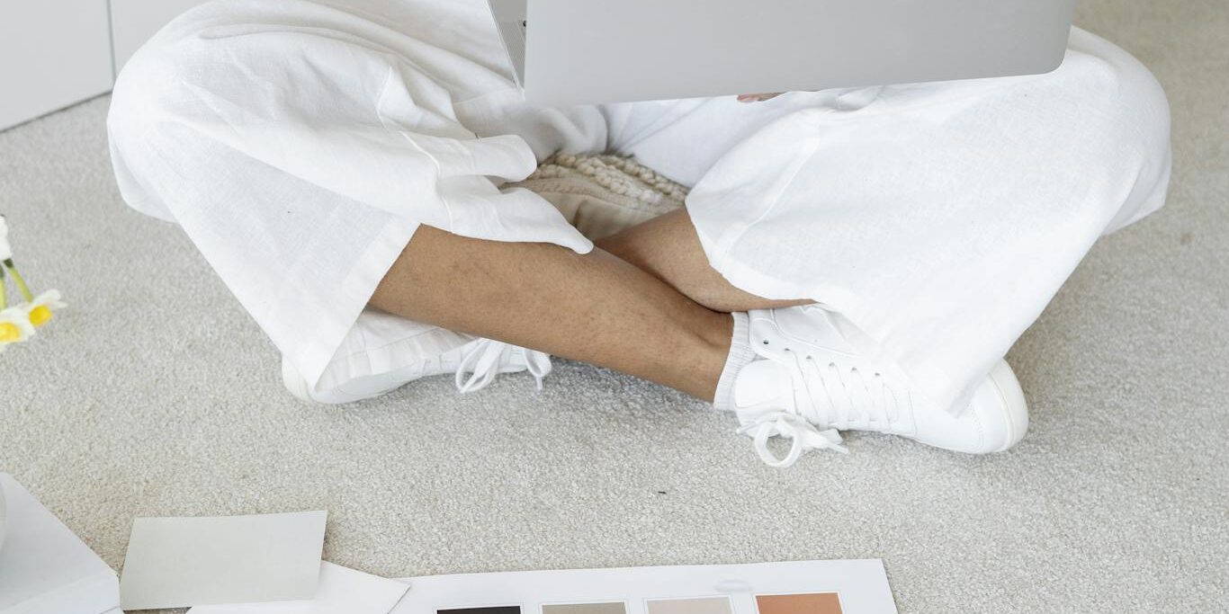 Person in White Scrub Suit Sitting on White Couch
